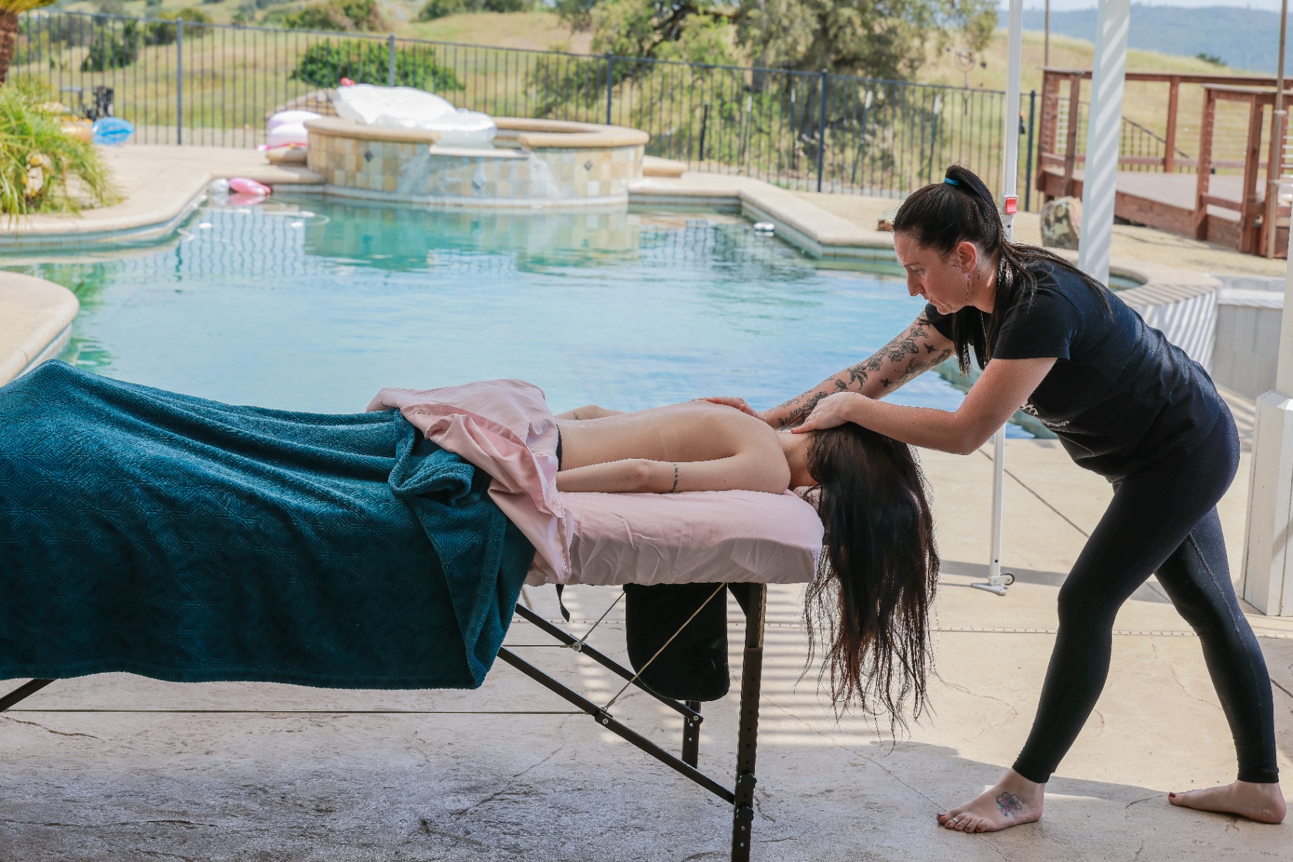 Poolside massage with rolling oak hills in the background