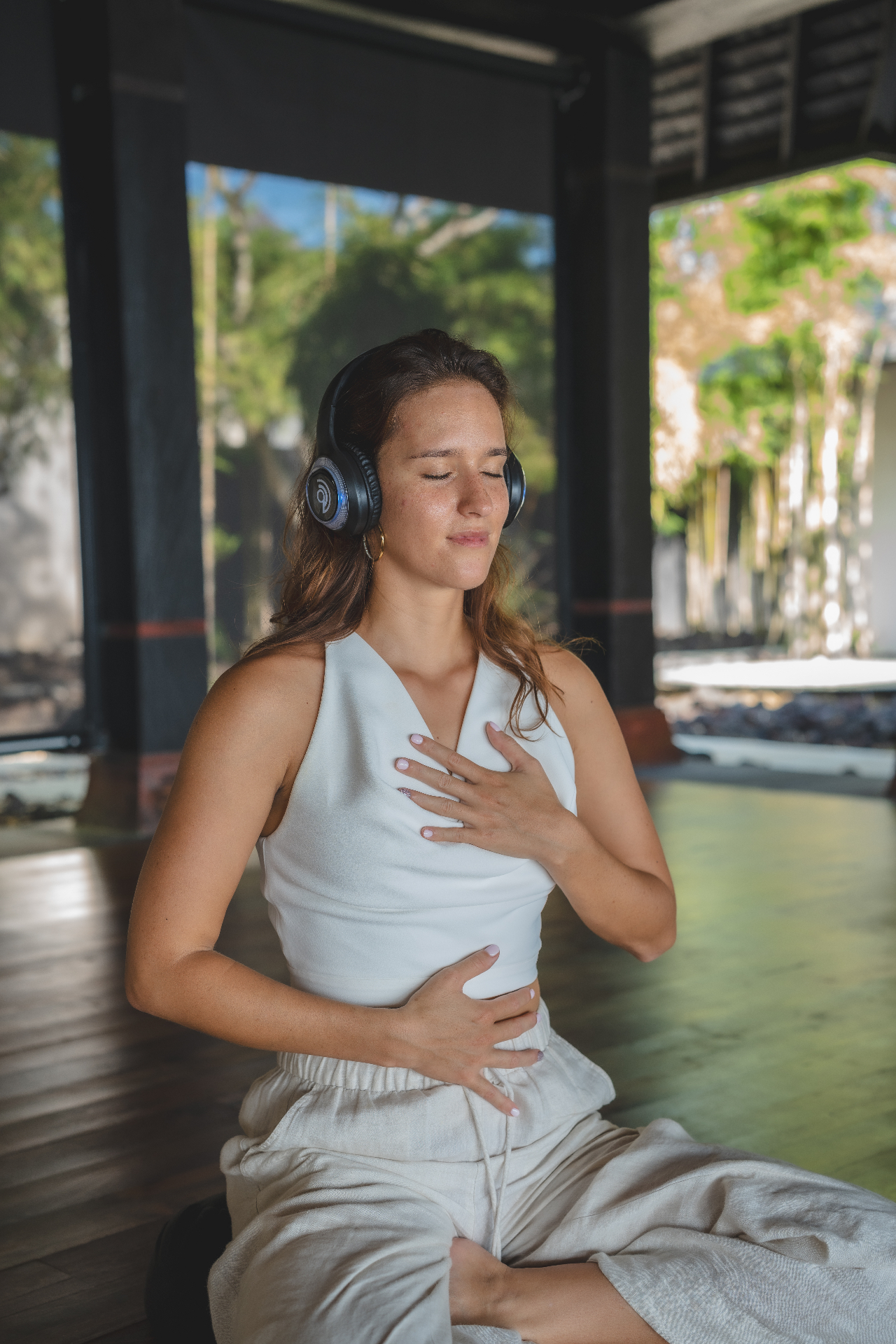 Woman relaxing at home with headphones during an online guided breathwork session